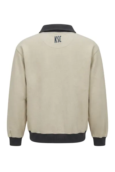 KSC Sweater, Cremefarben, 60 % Baumwolle, 40 % Polyester, Gestickter "Karlsruher Sport-Club Schriftzug" auf der Vorderseite, Die Buchstaben "KSC" im hinteren Nackenbereich, Dunkler Kragen mit praktischen Druckknöpfen, Retro-Design mit dunklen Bündchen